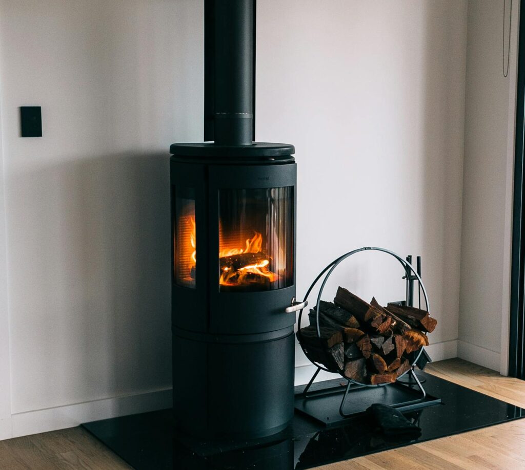 A cozy modern living room with a stylish fireplace and wood accents.